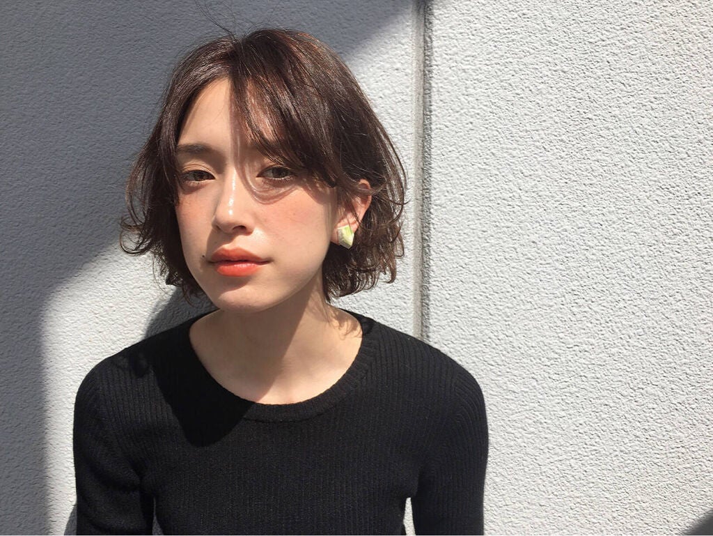 パーマをかけたボブヘアの女性