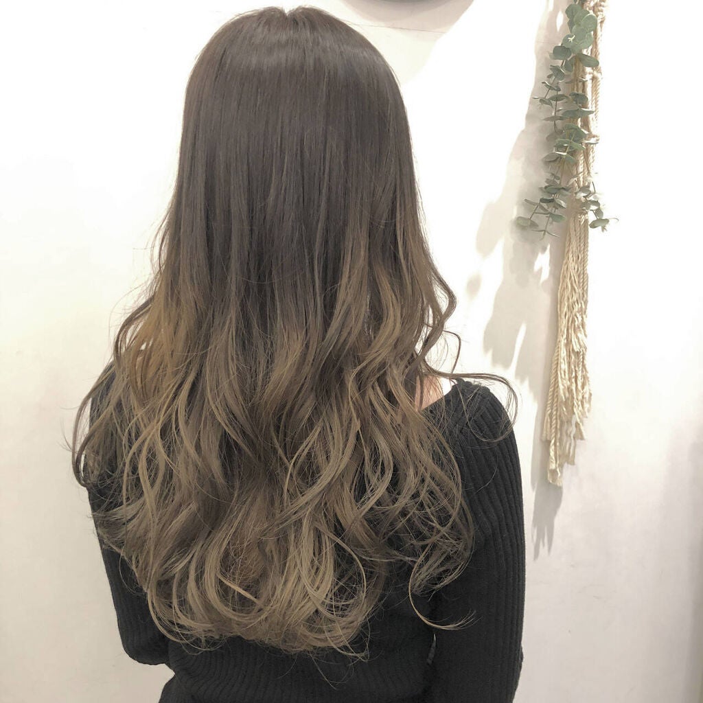 アッシュグリーンカラーをグラデーションで取り入れたロングヘアの女性の後ろ姿