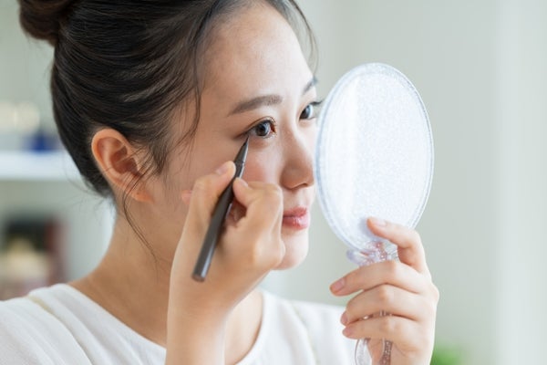 アイラインを引く女性