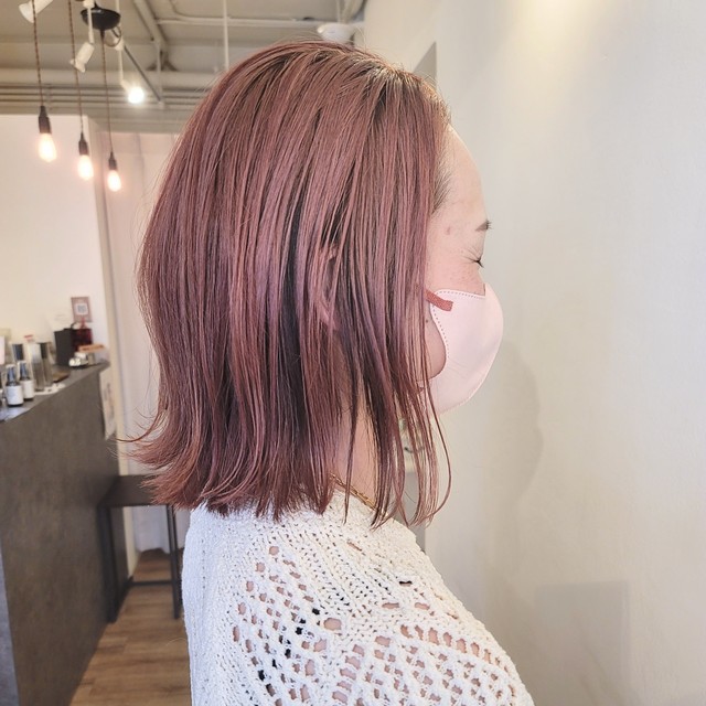 ピンク系で濡れ感のあるヘアスタイルの女性