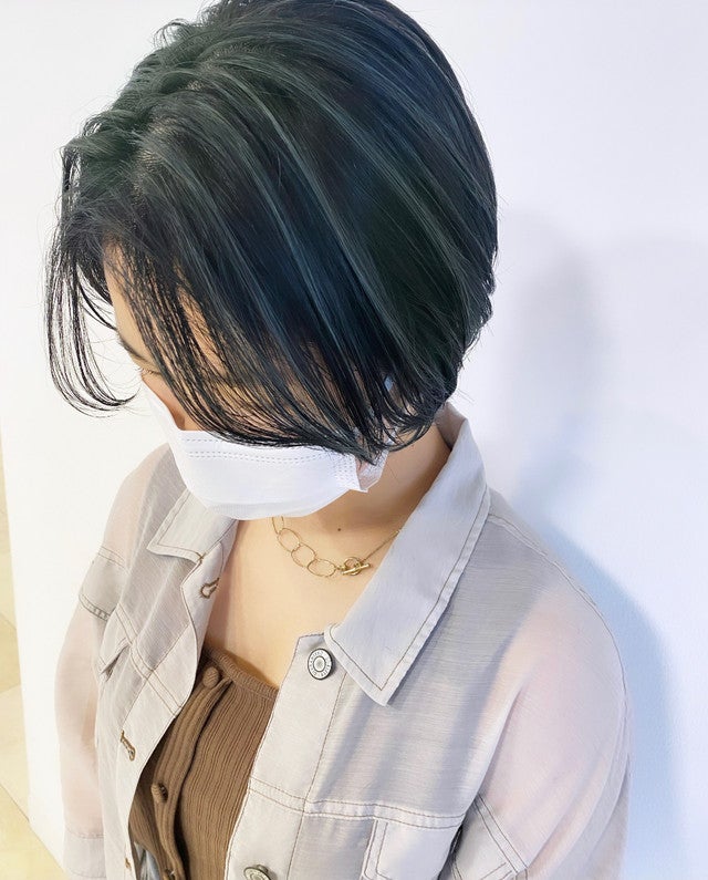 オリーブベージュの髪色のショートヘア女性