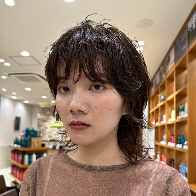 ショートヘアのゆるカールバングの女性