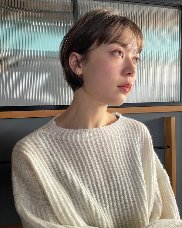 右上を見上げているショートカットの女性